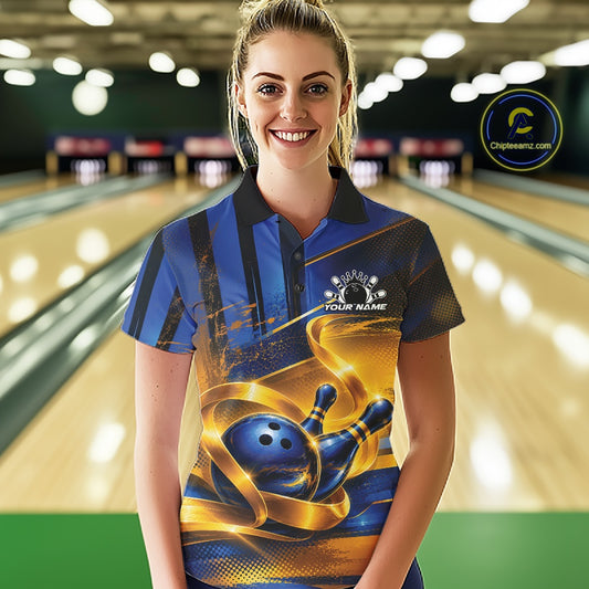 Front view of a female model wearing a bowling polo shirt with a glossy blue bowling ball and pins wrapped in elegant flowing gold ribbons at a bowling lane.