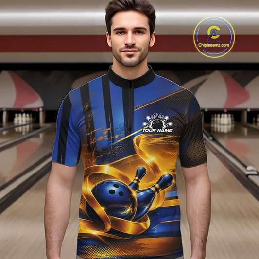 Front view of a male model wearing a bowling quarter zip shirt featuring a glossy blue bowling ball striking pins with elegant flowing gold ribbon accents in a bowling lane.