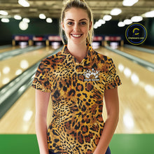 Load image into Gallery viewer, Smiling woman in a bowling alley wearing a gold, brown, and black leopard-print bowling polo with a small bowling pins graphic and “Your Name” on the chest.
