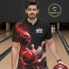 Load image into Gallery viewer, Front view of a male model in a bowling alley wearing a black bowling polo with a red flaming skull, lightning, bowling pins, and a custom name.
