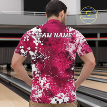 Load image into Gallery viewer, Person wearing a pink and white patterned bowling shirt with 'TEAM NAME' on the back, standing in front of a bowling alley.