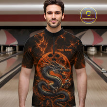 Load image into Gallery viewer, Front view of a male model in a bowling alley wearing an orange custom quarter-zip bowling shirt featuring an ancient dragon, flames, and a moon-inspired bowling ball design.