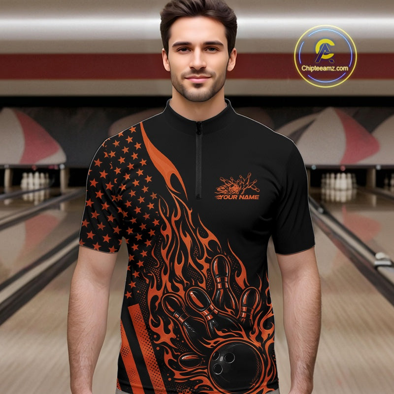 Male model at a bowling lane wearing a black bowling quarter-zip shirt with orange flame bowling strike artwork and patriotic graphics.