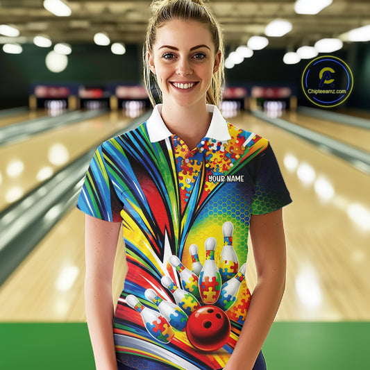 Female model in a bowling alley wearing a white polo shirt, front view featuring colorful autism bowling strike illustration with puzzle details