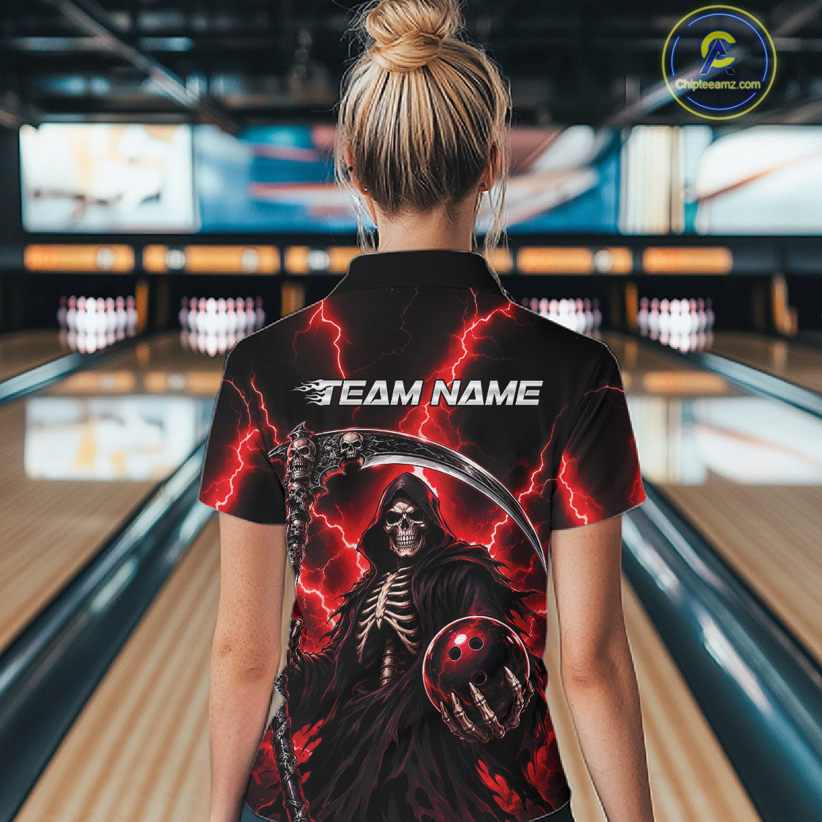 A woman viewed from behind wearing a black short-sleeve bowling shirt with a large grim reaper graphic, red lightning, and the text 'TEAM NAME' on the back. 