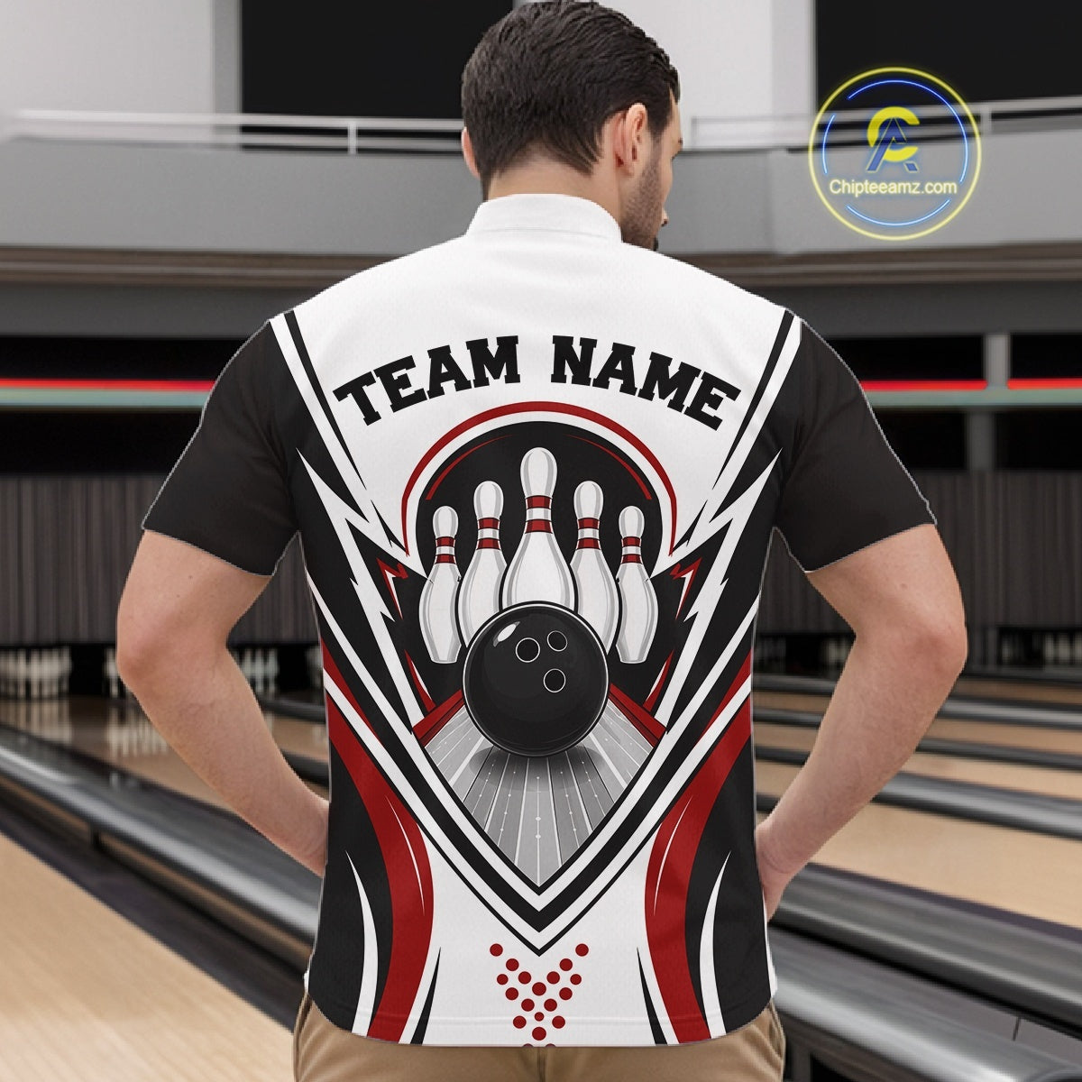 Front view of a male model wearing a white, black, and red bowling quarter zip shirt with bowling strike artwork of a bowling ball and pins in a bowling lane.