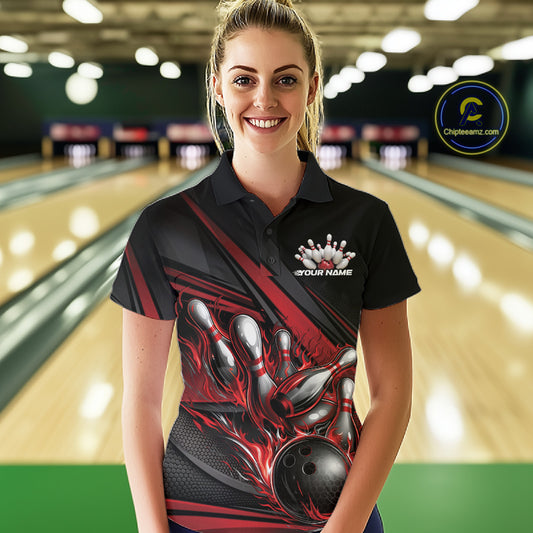 Female model at a bowling lane, front view wearing black polo shirt with red flame bowling ball hitting pins and stripe accents