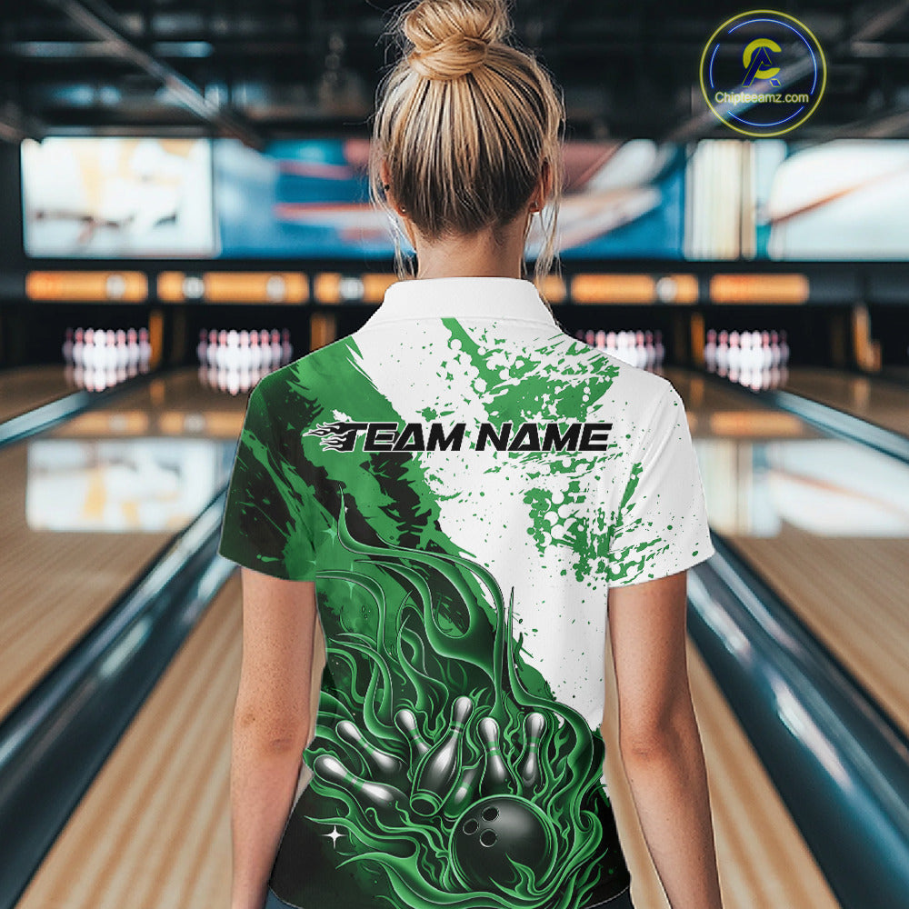 Back view of a female model in a bowling lane wearing a black, green and white flame bowling quarter-zip shirt featuring dynamic bowling strike artwork.