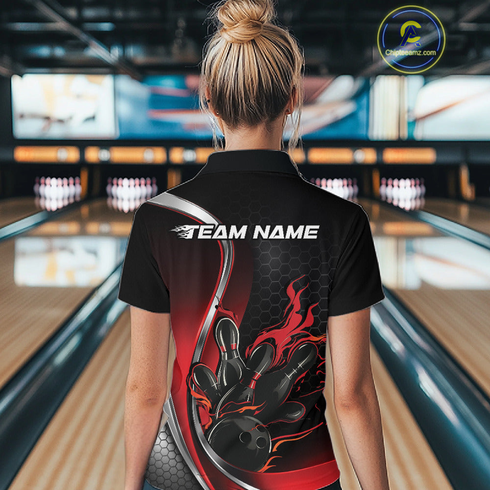 Back view female model inside bowling center wearing black and red quarter zip shirt featuring flame bowling ball hitting pins design