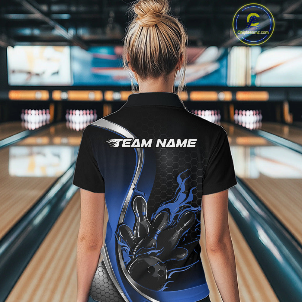 Female model back view at bowling lane wearing black and blue quarter zip shirt featuring flame bowling ball and pins action graphic