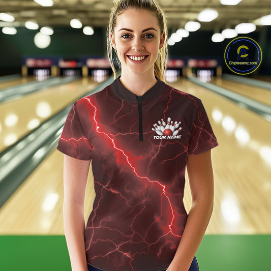 Female model at the bowling lane wearing a quarter-zip with red cobra artwork and lightning fantasy styling.