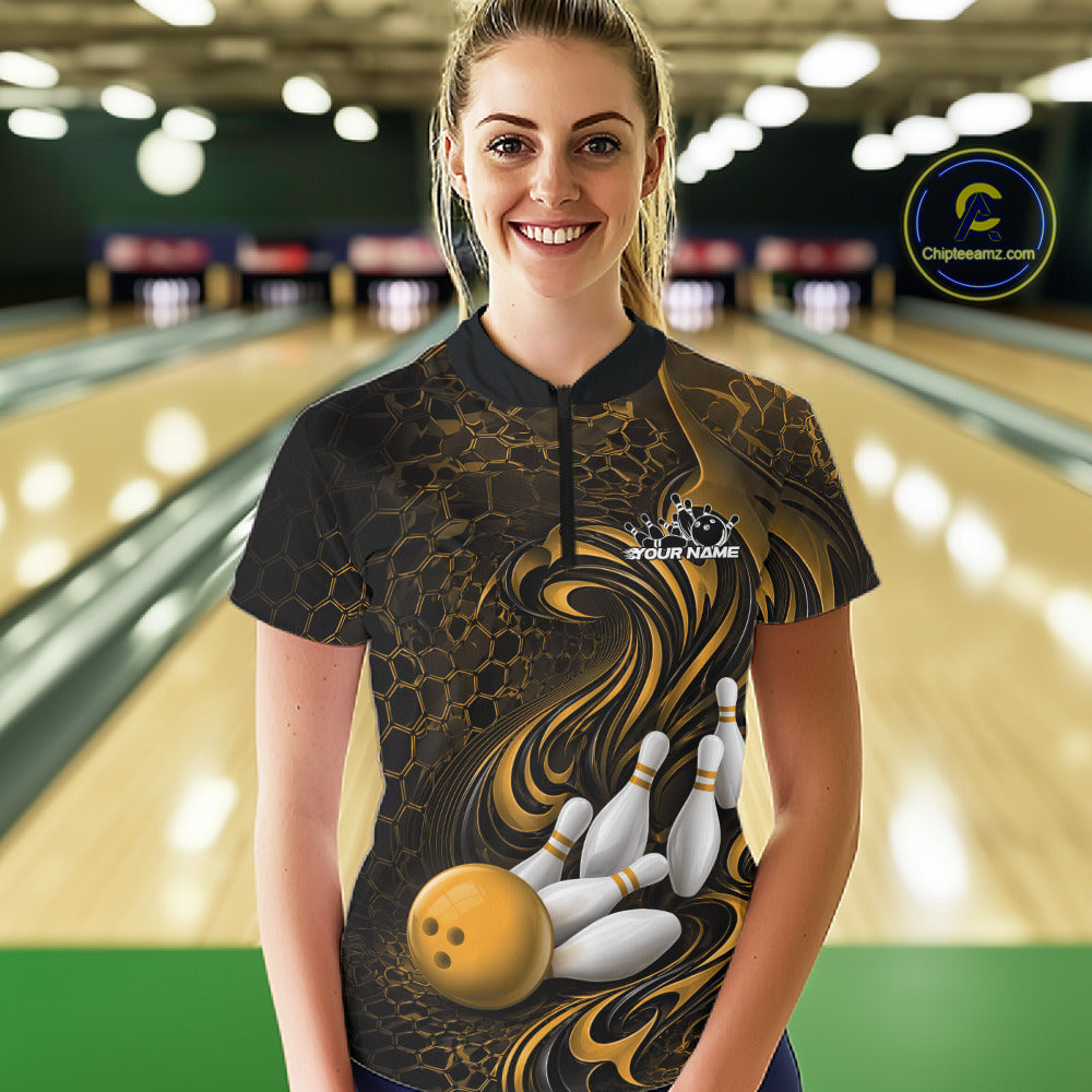 Female model wearing a black and yellow bowling quarter-zip shirt in a bowling alley featuring a tribal flame bowling ball and pins graphic