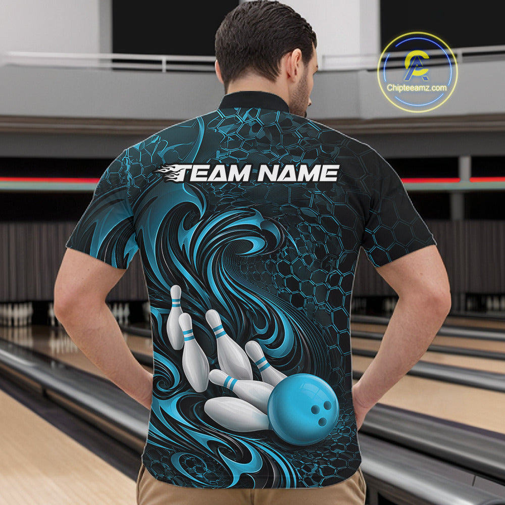 Male model wearing a black and blue bowling quarter-zip shirt in a bowling alley featuring a tribal flame bowling ball and pins graphic