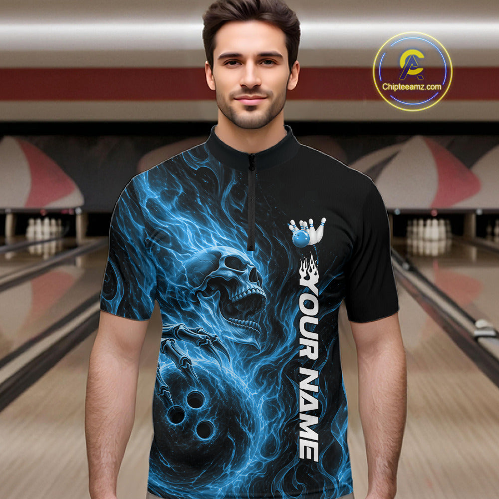 Male model wearing a black bowling quarter-zip shirt in a bowling alley featuring a skull clutching a bowling ball with swirling blue energy flames