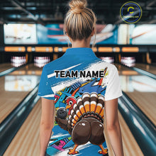 Load image into Gallery viewer, Back view of a female model wearing a blue custom bowling polo shirt with a funny graffiti turkey holding a bowling ball, paint splatter accents, and a personalized name in a bowling alley.