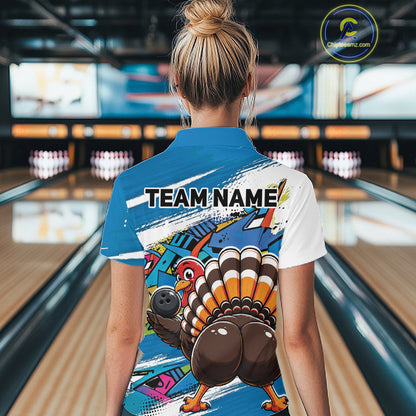 Back view of a female model in a bowling alley wearing a blue custom quarter zip bowling shirt with a funny graffiti turkey holding a bowling ball, paint splatter accents, and a personalized name.