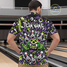 Load image into Gallery viewer, Male model wearing a green and purple bowling quarter-zip shirt in a bowling lane showcasing a mischievous green monster bowling ball with sharp teeth, a purple tongue, playful hand gesture, and cheerful cartoon bowling pins.