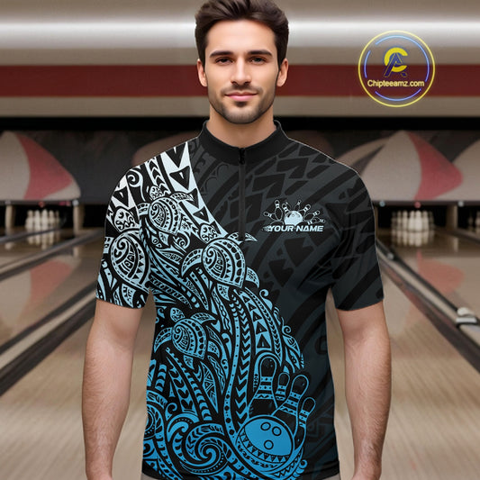 Male model wearing a black and blue bowling quarter-zip shirt at the bowling lane with turtle pattern bowling graphics.