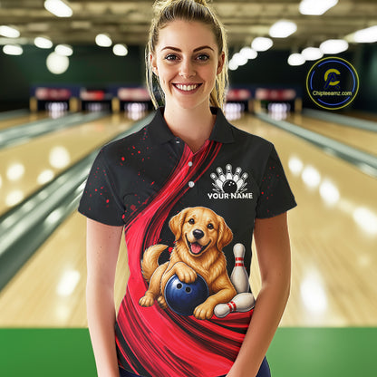 A woman standing in a bowling alley wearing a black and red custom bowling t-shirt with a graphic of a golden retriever holding a bowling ball and pin. The shirt has a white customizable name print on the chest.
