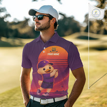 Load image into Gallery viewer, Man wearing a purple golf shirt with a cartoon character on a golf course