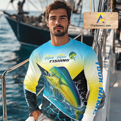 A man wearing a long-sleeve Mahi-Mahi Fishing graphic shirt on a boat deck, with a wooden Chipteeamz logo sign in the upper right corner.