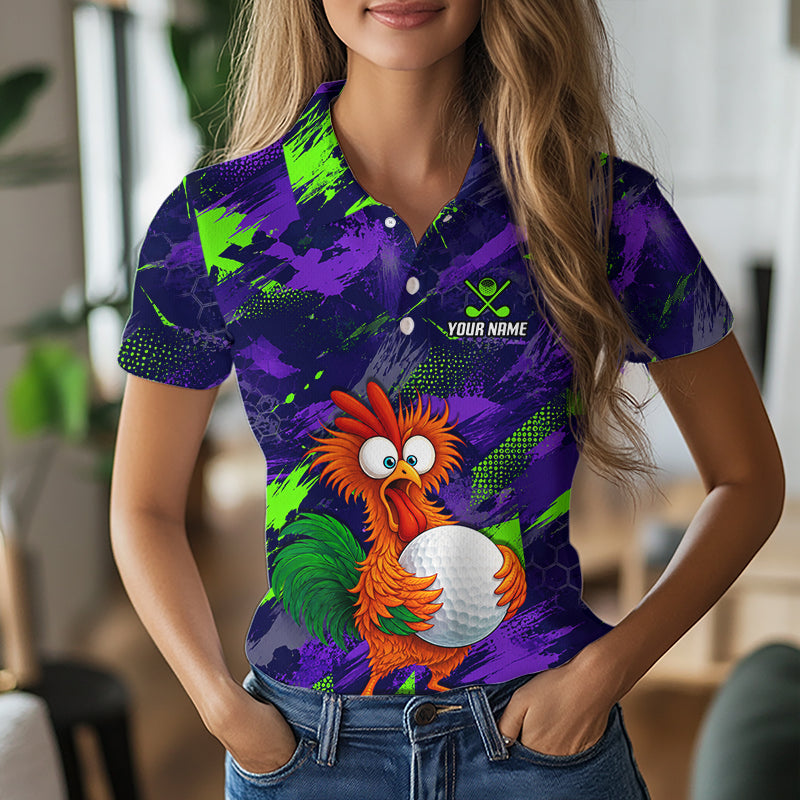 A woman wearing a short-sleeve polo shirt with a vibrant purple and green abstract background and a cartoon rooster holding a golf ball graphic on the front. The shirt includes a customizable name print area on the chest.