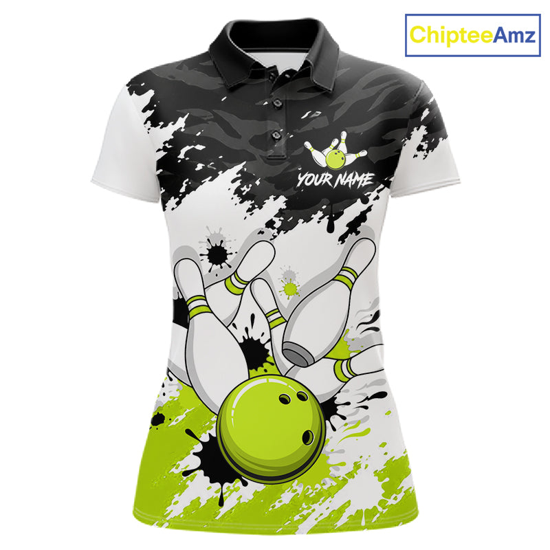 A women's short-sleeve polo shirt with a bowling-themed graphic print. The design features a black and white splatter/camo pattern on the upper chest and shoulders, white bowling pins, and a bright lime green bowling ball at the bottom.