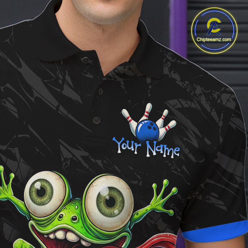 A close-up of a person wearing a black short-sleeve polo shirt with a cartoon graphic of a green monster and bowling pins. The shirt has a custom text placeholder reading 'Your Name' next to the bowling motif.