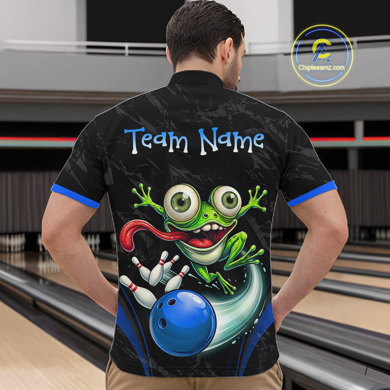 A man viewed from behind wearing a black bowling-themed short-sleeve shirt with a large green cartoon frog, blue bowling ball, and 'Team Name' text on the back, standing in a bowling alley.