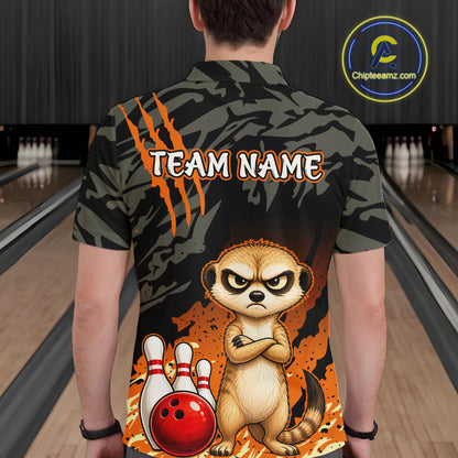 A person shown from behind wearing a short-sleeve bowling-themed shirt with a dark camouflage pattern, orange claw marks, the text 'TEAM NAME', and a cartoon meerkat standing in front of bowling pins and a red bowling ball. The background is a blurred bowling alley.