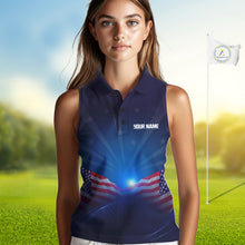 Load image into Gallery viewer, Woman wearing a blue sleeveless shirt with an American flag design on a golf course.