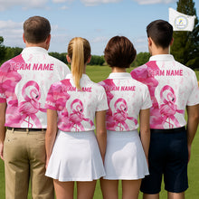 Load image into Gallery viewer, Four people in matching pink and white flamingo breast cancer awareness golf outfits on a golf course with "Team Name" on the back.