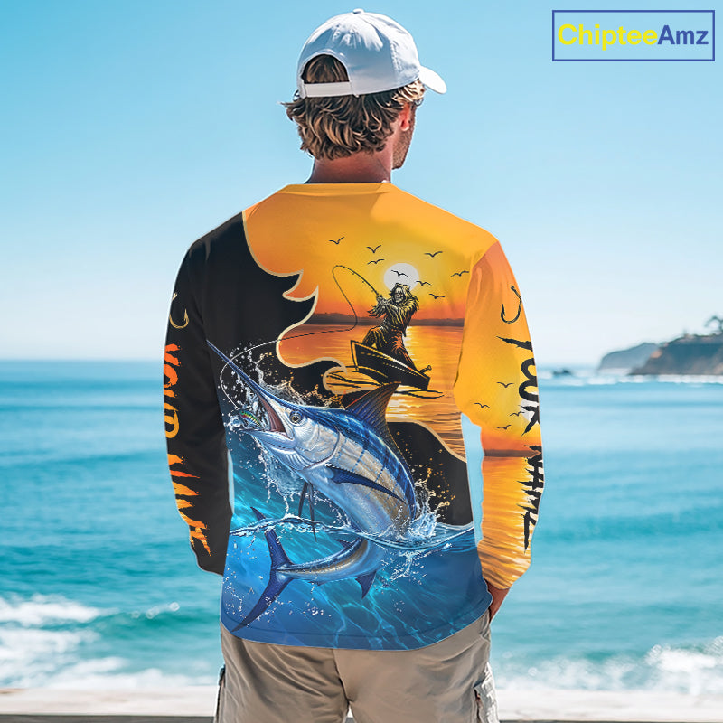 Person wearing a saltwater fishing-themed long sleeve fishing shirt with a sunset and fish reaper design, standing on a boat.
