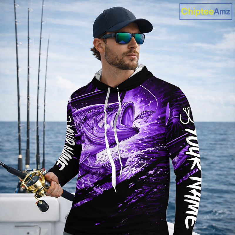 Man wearing a long sleeve hooded fishing shirt with a purple bass fish design on a boat