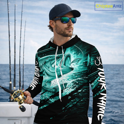 Man wearing a long sleeve hooded fishing shirt with a teal bass fish design on a boat
