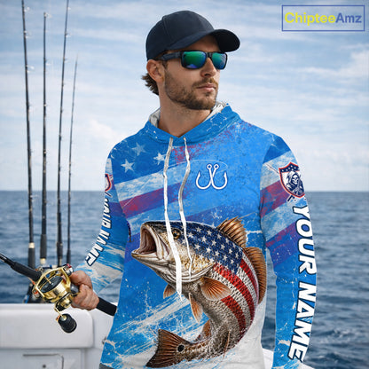 Man wearing a blue patriotic bass fishing shirt with custom name, standing on a boat
