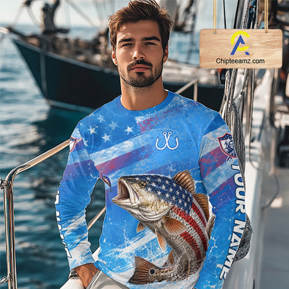 Man wearing a blue patriotic redfish fishing shirt with custom name, standing on a boat