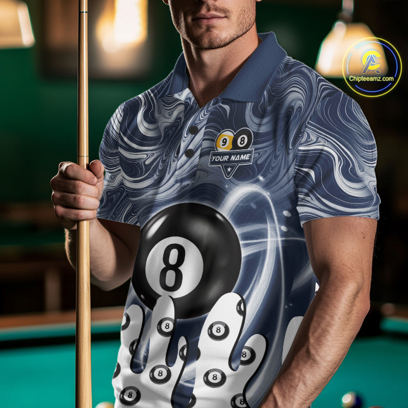 Man wearing a blue marble swirl 8 ball and 9 ball billiard jersey beside a pool table front view.