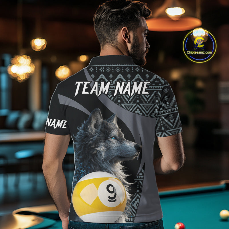 Man wearing a shirt with a wolf and pool ball design, standing in a bar.