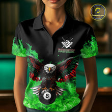 Load image into Gallery viewer, Woman wearing a green flame eagle skull billiard jersey beside a pool table front view.