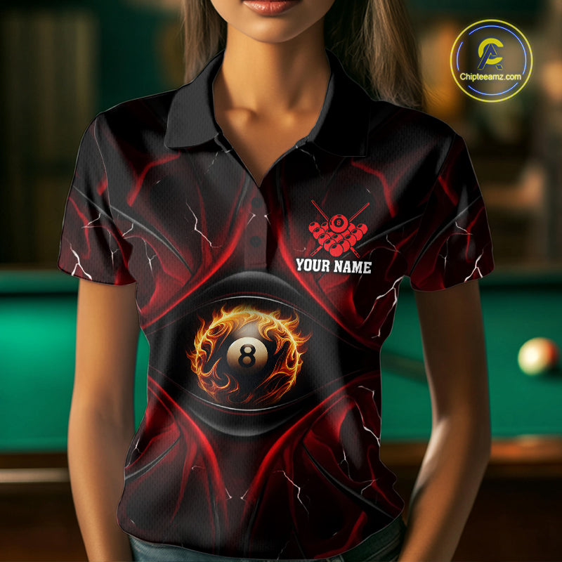Woman wearing a black and red flame 8 ball billiard jersey beside a pool table front view.