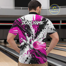 Load image into Gallery viewer, Back view of man wearing a pink splatter bowling quarter zip shirt in a bowling alley.