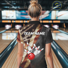 Load image into Gallery viewer, Back view of woman wearing a retro American flag bowling polo shirt inside a bowling alley.
