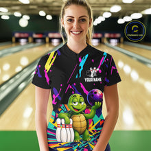 Load image into Gallery viewer, Person wearing a black bowling shirt with colorful design and turtle graphic in a bowling alley.