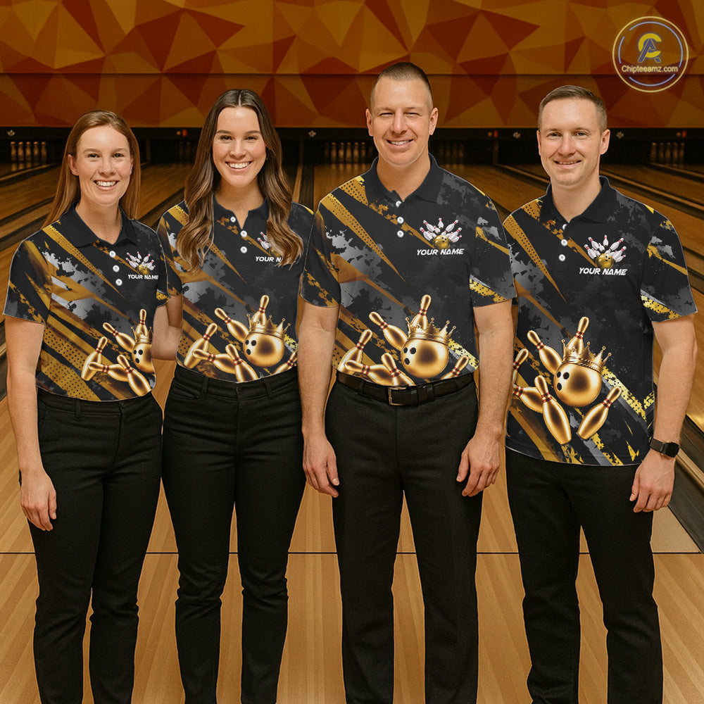 Four people wearing matching bowling shirts in a bowling alley.