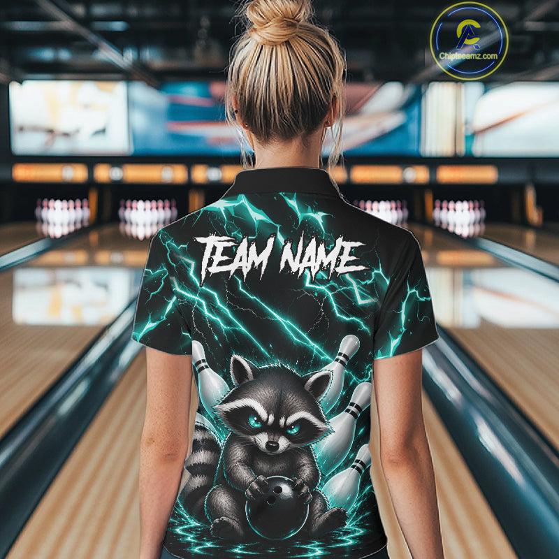 Back view of woman wearing a turquoise neon lightning raccoon bowling polo shirt inside a bowling alley.