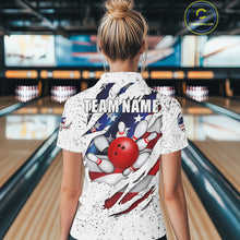 Load image into Gallery viewer, Back view of woman wearing a white grunge American flag eagle bowling polo shirt inside a bowling alley.
