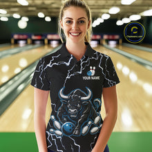Load image into Gallery viewer, Woman wearing a blue bull lightning bowling polo shirt at a bowling alley front view.
