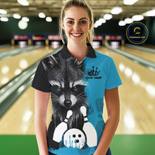 Load image into Gallery viewer, Woman wearing a black and blue raccoon bowling polo shirt at a bowling alley front view.