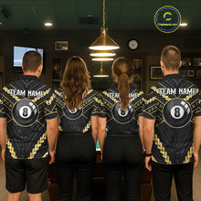 Load image into Gallery viewer, Back view of pool players wearing matching black and gold tribal billiard shirts in a game room.